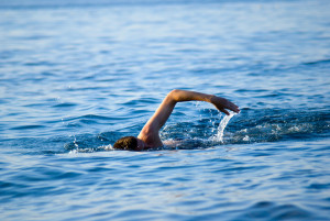 swimming man in ocean water